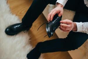 Business man or groom dressing up with classic elegant shoes. photo