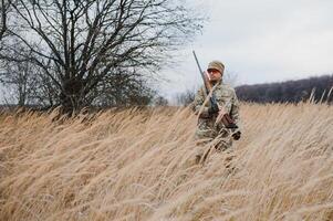 Hunting permit. Man brutal gamekeeper nature background. hunter spend leisure hunting. Hunter hold riffles. Focus and concentration of experienced hunter. Hunting and trapping seasons photo