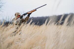 caza permiso. hombre brutal guardabosque naturaleza antecedentes. cazador gastar ocio caza. cazador sostener rifles. atención y concentración de experimentado cazador. caza y captura estaciones foto