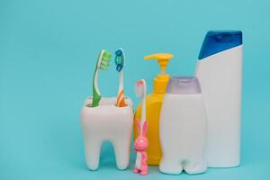 Shower accessories on a colored background. bathroom setting on blue background. means of body hygiene photo