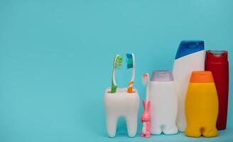 Shower accessories on a colored background. bathroom setting on blue background. means of body hygiene photo