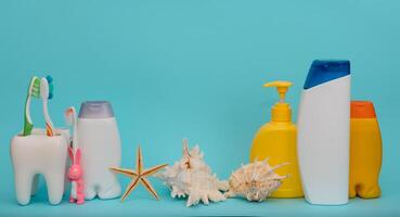 Shower accessories on a colored background. bathroom setting on blue background. means of body hygiene photo