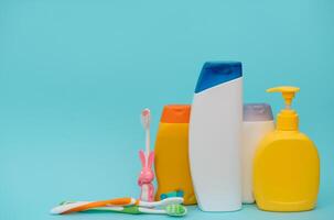 Shower accessories on a colored background. bathroom setting on blue background. means of body hygiene photo