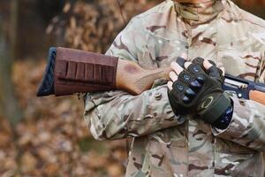 Hunter handsome guy with weapon. Hunter spend leisure hunting. Hunting equipment. Brutal masculine hobby. Man observing nature background. Hunter hold rifle. Safety measures. Natural environment photo