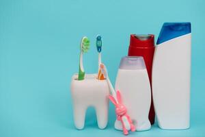 Shower accessories on a colored background. bathroom setting on blue background. means of body hygiene photo