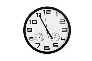 simple classic black and white round wall clock isolated on white. Clock with arabic numerals on wall shows photo