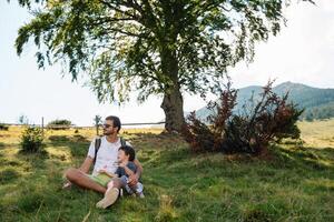 Son with father on mountain photo