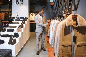 Handsome young african man wearing suit in shop photo