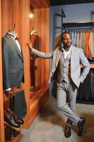 Handsome young african man wearing suit in shop photo