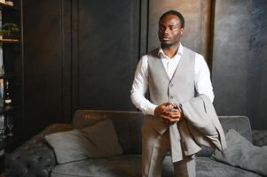 African man in a classic suit on a dark gray background. The concept of classic clothing photo