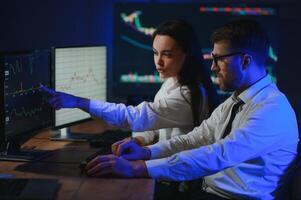 Financial Analyst Talking to Investment Banker in Late Evening at Work photo