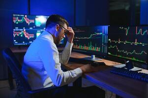 Financial Analysts and Day Traders Working on a Computers with Multi-Monitor photo