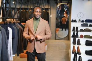 Handsome young african man wearing suit in shop photo