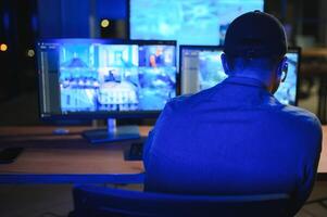 Male security guard in surveillance room photo