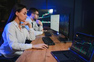 Financial Analyst Talking to Investment Banker in Late Evening at Work photo