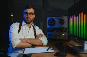 A male spy listens and records conversations on a reel-to-reel tape recorder photo