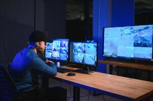 Male security guard in surveillance room photo