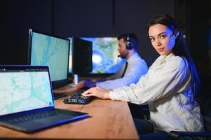 Friendly smiling woman call center operator with headset using computer at office photo