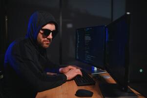 Hacker is hacking into the computer network. Computer criminal photo