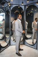 A handsome young african gentleman buying an elegant suit photo