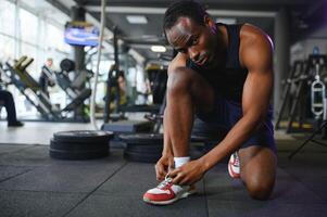 Young African-American man in a gym preparing to exercise photo