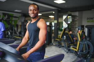 Sports, fitness, healthy lifestyle. African man in the gym. photo