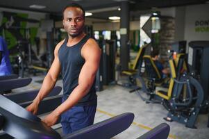 Black African American young man doing cardio workout at the gym photo