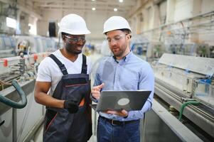 dos trabajadores a el fábrica. ingeniero y trabajador foto