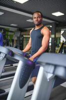 Man running on treadmill in gym photo