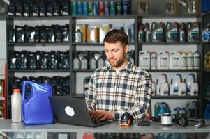 Auto parts store. The seller receives the product and evaluates the quality photo
