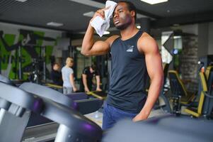 Man running on treadmill in gym photo