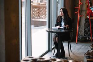 businesswoman talking on the phone and taking notes photo