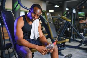 Young African-American man in a gym preparing to exercise photo