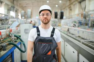 Portrait of factory worker. Young handsome factory worker photo