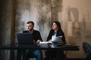 business man and woman working behind laptop. photo