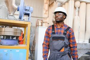 Portrait of industrial engineer. factory worker standing in factory production line photo