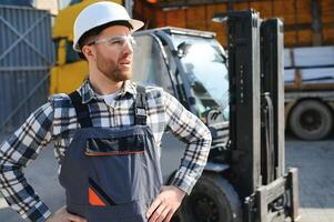 Man worker at forklift driver happy working in industry factory logistic ship photo