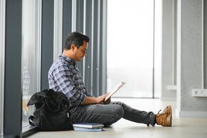 Portrait of cheerful male international Indian student with backpack. Education concept photo