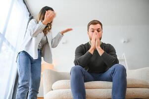 Family conflict, quarrel, misunderstanding. The woman shouts at her husband, in despair, crying photo