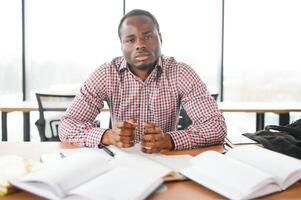 Male student sitting in university classroom. Man sitting in lecture in high school classroom. photo