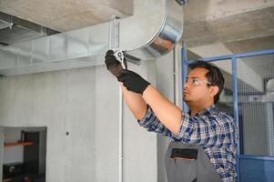 Ventilation cleaning. Specialist at work. Repair ventilation system. Industrial background photo