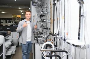 Man chooses a products in a sanitary ware store photo