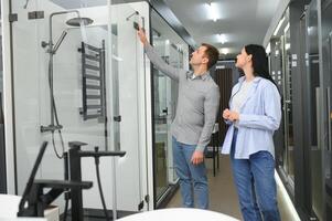 Young couple choosing new bathroom furniture photo