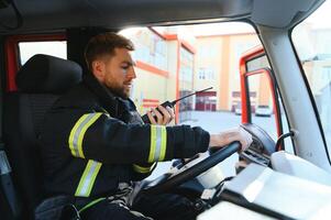 Firefighter drives a emergency vehicle with communication interior view photo