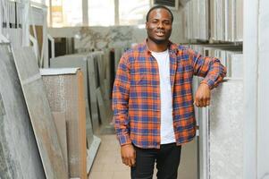 African american man choosing tiles at building market photo