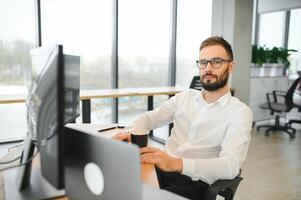 Crypto trader sits at his workplace in front of a monitor with charts. photo