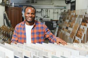 African american man customer choosing ceramic tile at building materials store photo