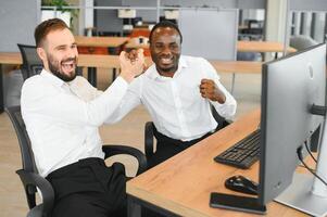 Two stock exchange traders getting profit in trading currency stock. Successful stock exchange showing financial benefit data on monitor screen at highest point of neon light at workplace. Sellable photo