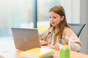 Smiling little Caucasian girl have call distant class with teacher photo