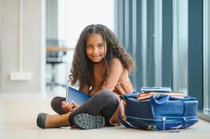 Portrait of cute African-American girl at school photo